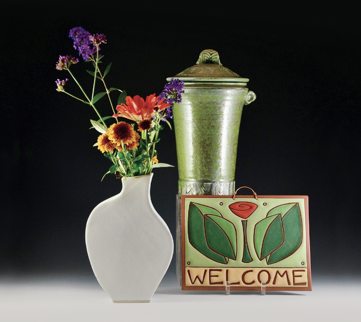Left to right: Evelyn LaMers’ stoneware vase, Janet Murie’s stoneware covered jar, Kate Lally’s earthenware tile.