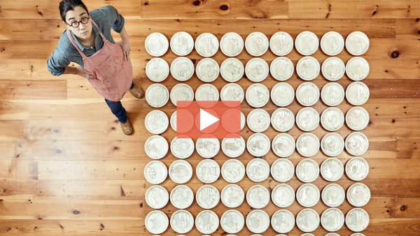 Image of Ayumi Horie from above with a grouping of plates.