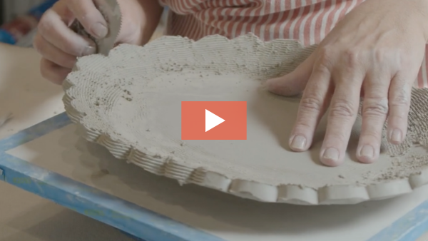 Image of Angelique Tassistro refining the scalloped edges of a slab-built platter