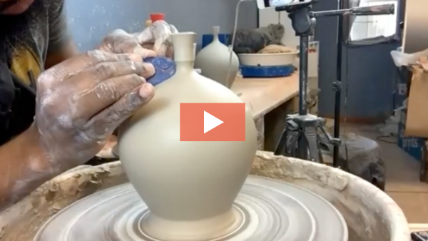 Image of Stephen Phillips refining a narrow-necked ceramic vase