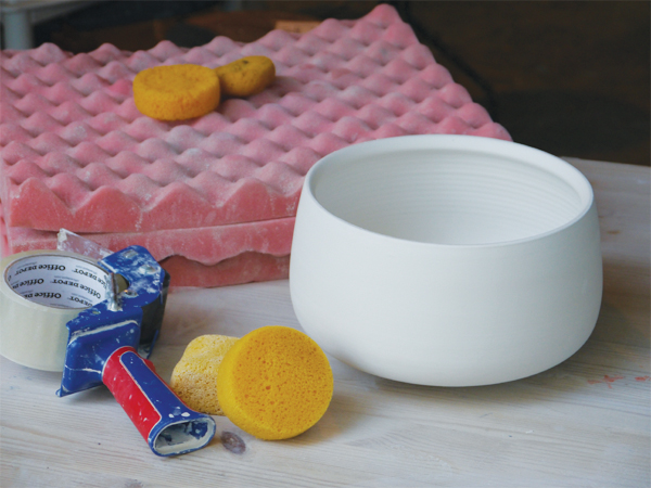 1 Supplies needed for etching on bone-dry clay: packing tape, padding, sponges, a bone-dry pot, and clean water.