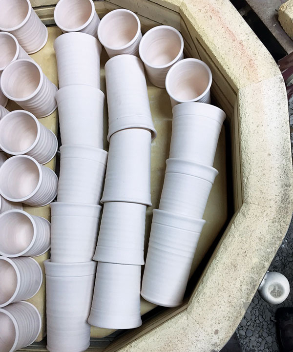 6 Laying down pots and nesting to use all the space for a bisque firing.