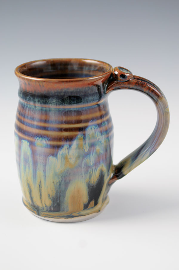 Porcelain mug, 5 in. (13 cm) in diameter, Dave’s porcelain, Red-Black Glaze top and bottom (applied first), Mel’s Orange Underglaze dots applied to the middle, Rutile Base glaze (applied last), fired to cone 10 in reduction.