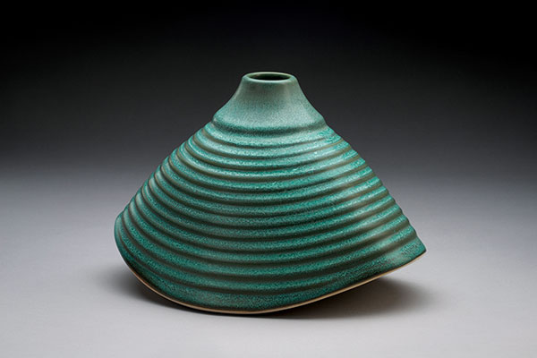 10 Beth Armour’s bronze green rocking vessel, 10 in. (25 cm) in length, porcelain, fired to cone 6.