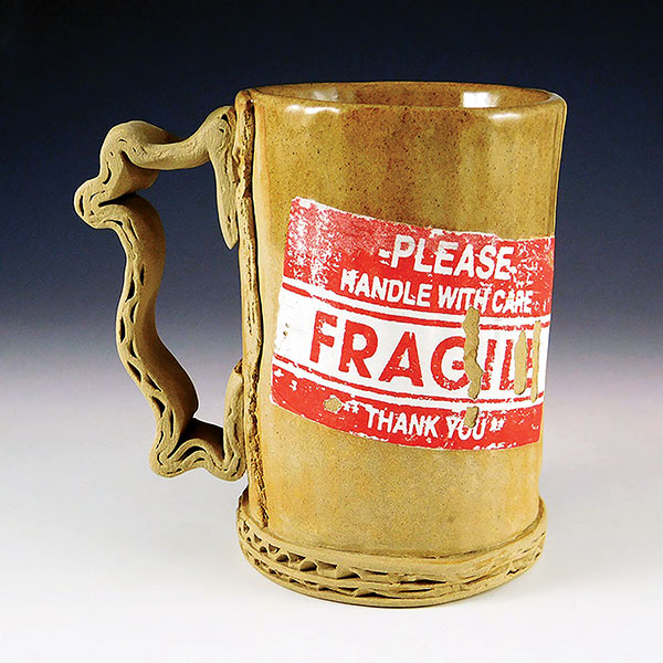 7 Tim Kowalczyk’s Fragile Mug, 5 in. (13 cm) in width, handbuilt and press-molded dark stoneware, silkscreen-printed underglaze transfers, fired to cone 6 in oxidation, 2017. 