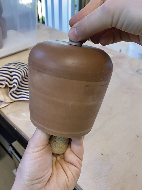 4 Press a stamp into the supported base of your pot.