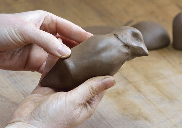 2 Sculpt the bird out of a solid piece of clay, and create an indent where the bird will attach to the candlestick.