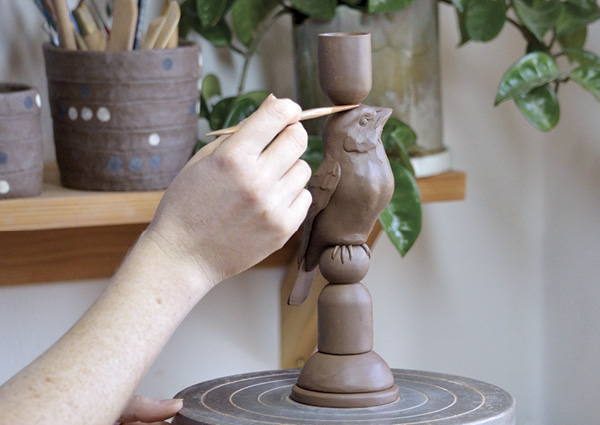 14 Score and attach candle holder to the top of the bird form.