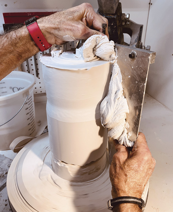 3 Begin to introduce your profile tool to the cast plaster while turning on your wheel.
