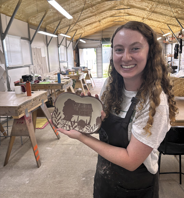6 Roby Summerfield showing off her tray made with stencils she designed and printed on a Cricut Cutter in Sam Oliver’s 2025 workshop, “Into The Weeds with Stencils on Clay.”