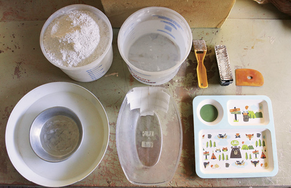 1 Set up your space with plaster, water, vessels, and a selection of tools.