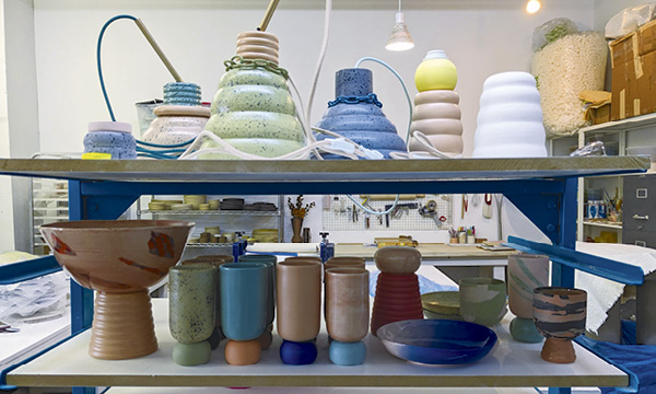 3 Pendant lamps, bowls, goblets, and compotière in stained porcelain sit on Anderson’s shelves. Photo: Lysanne Larose.