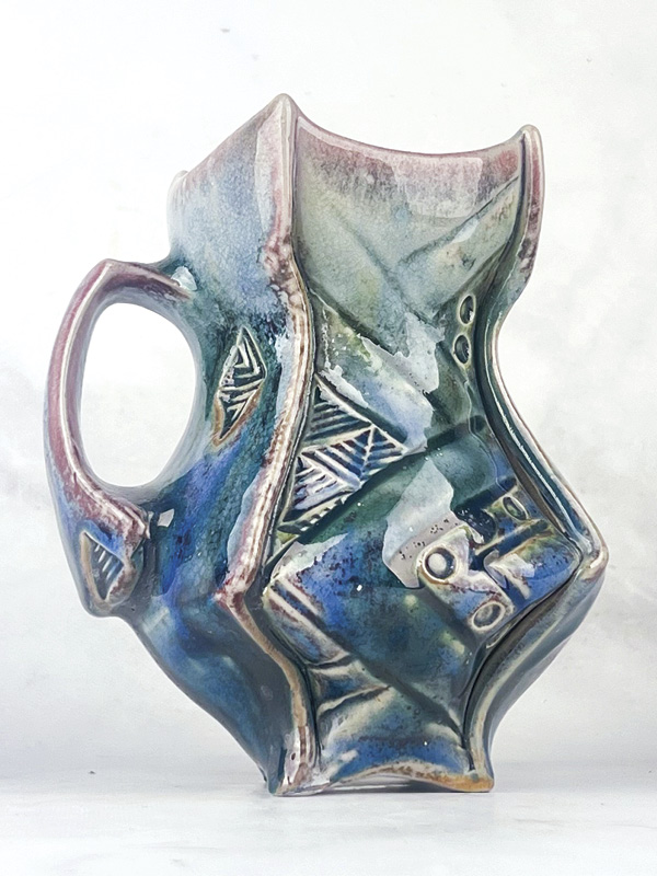 Samuel Newman's Glacier Maker’s Mug, 51/2 in. (14 cm) in height, Laguna B-Mix 10 (porcelaneous stoneware), thin spray of Tenmoku, Galactic Indifference sprayed as a second layer, fired in reduction to cone 12 in a soda kiln, 2024.