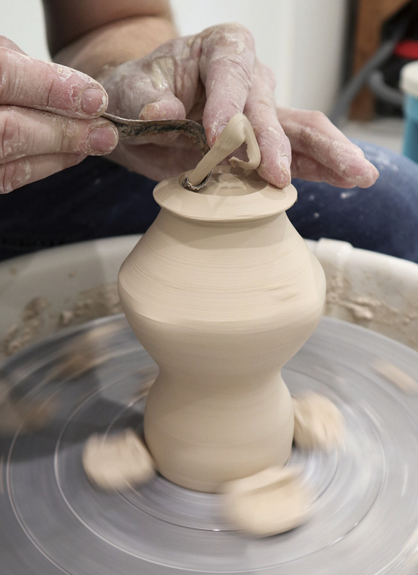 5 Trim excess clay from the lower third of the cylinder to lighten and accentuate its shape.