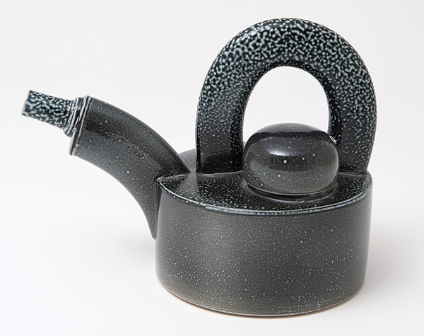 9 Walter Keeler's Teapot with Oval Extruded Spout & Handle, 81/2 in. (22 cm) in width, stoneware, black stain, salt glaze, oil fired to cone 6–10, 2017. Photo: Goldmark Gallery.