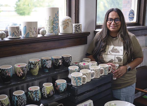 6 Yesha Panchal showcasing pots during the 2024 Michiana Pottery Tour at Sadie Misiuk’s Goshen, Indiana, studio.