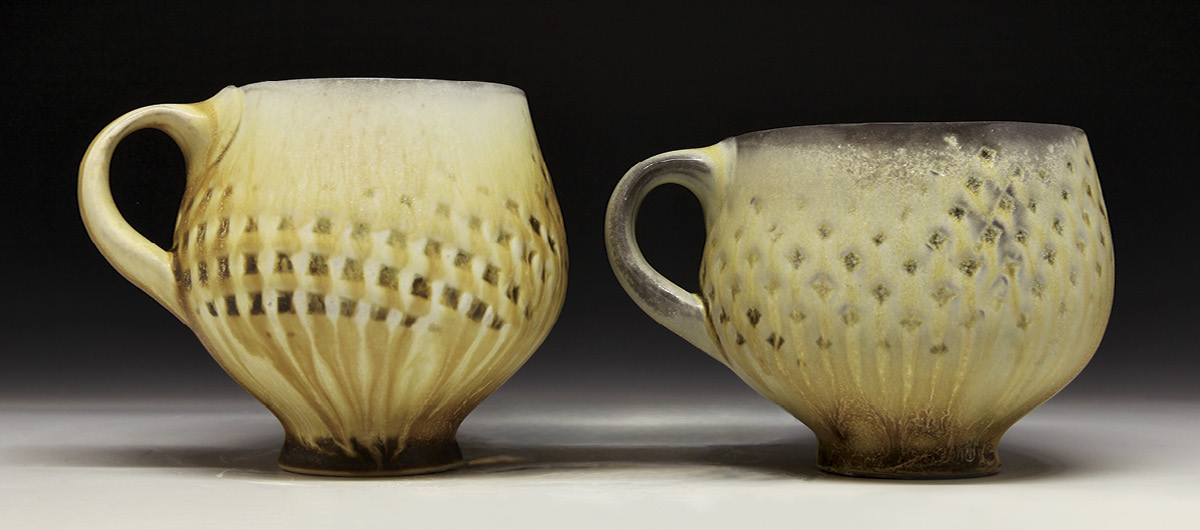 Ben Eberle's Cappuccino mugs, to 3 in. (7.6 cm) in height, wheel-thrown and embossed Laguna B-Mix clay, fired to cone 10 in a wood-soda kiln, 2025.