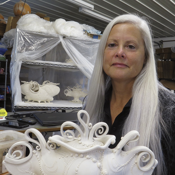 2 Carol Long with greenware in her studio, 2024.