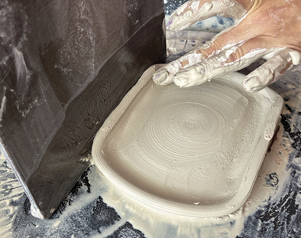 7 Continue compressing the flattened side to fully close the dart.