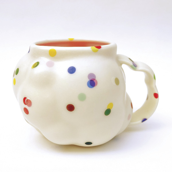 4 Nate Ditzler and Laura Konecne’s Confetti Series: Large Cloud Mug, 5¾ in. (15 cm) in width, translucent pigmented porcelain, glaze, overglaze, fired to cone 6 in oxidation, 2023.