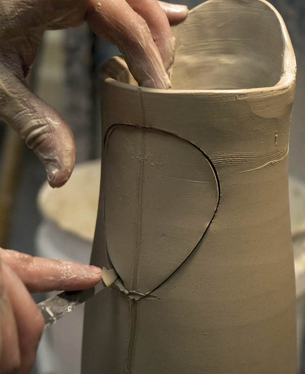 4 Cut a teardrop-shaped dart from the back of the pitcher.