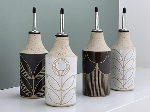 1 Selection of oil/vinegar bottles, 7 in. (18 cm) in height, light speckled stoneware, sgraffito, wax resist.