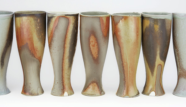 4 Johnny Arvizu’s iced tea tumblers, to 8 in. (20 cm) in height, Jackie Head’s casting clay body, Arvizu Variation of Bisque Flash Flashing Slip, soda fired to cone 10, reduction cooled.