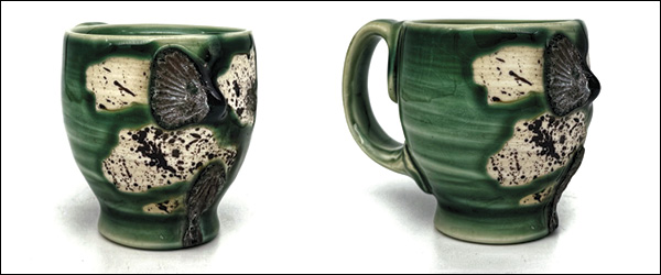 10 A mug side-fired on shells and wadding in a mid-range electric kiln, splattered with oxide wash. A drip can be seen on the right, point out, where it was fired on its side.