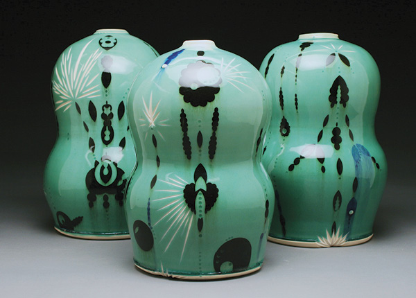 6 Molly Johnson’s Waisted Vessels, 11 in. (28 cm) in height each, porcelain, black-and-blue stencil designs, surface lathe cuts, green celadon glaze, 2023.