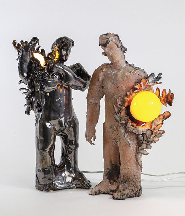 1 Jinsik Yoo’s Messengers, no.7 and no.8 (with lights) (left to right), 10½ in. (26.7 cm) and 11 in. (27.9 cm) in height, glazed earthenware, light bulbs, 2024.