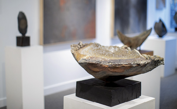 3 Gallery view with Threshold (center), 27 in. (68.6 cm) in width, anagama-fired stoneware, 2024. Photo: Roan Callahan.