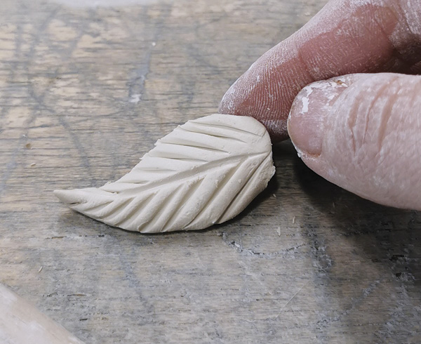 7 Carve leaf shapes and refine them with a needle tool.