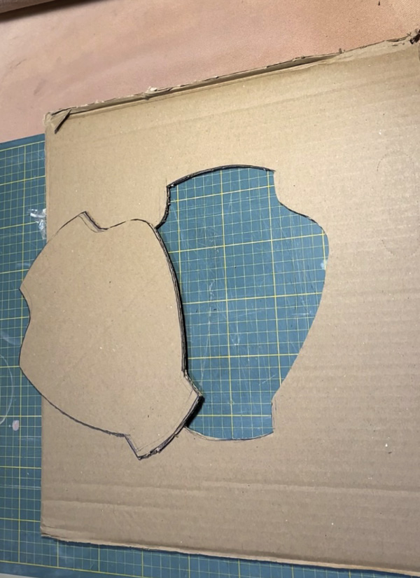 2 Cut the symmetrical vessel profile out of the center of a large piece of cardboard.