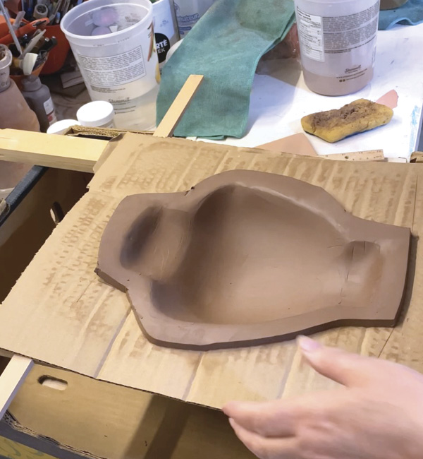 5 Form one slab into the cardboard slump mold.