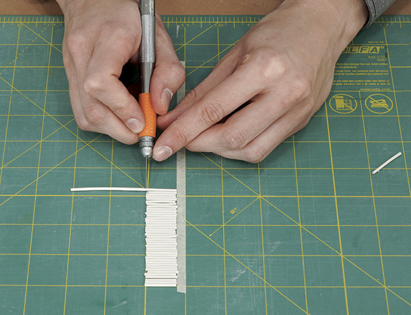 5 Pre-cut dry sticks of clay with an X-Acto blade on a self-healing cutting mat using a tape guideline.