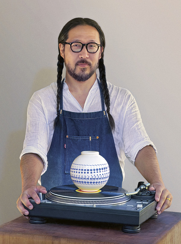 1 Caravan Moon Pot, 6 in. (15.2 cm) in height, stoneware, glaze, glass enamel, 2025. Pictured on a record turntable with Daniel Young Kim.