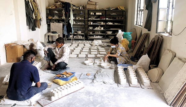 2 Mathur in a Jaipur Blue Pottery workshop with senior artisans in Jaipur, 2020.
