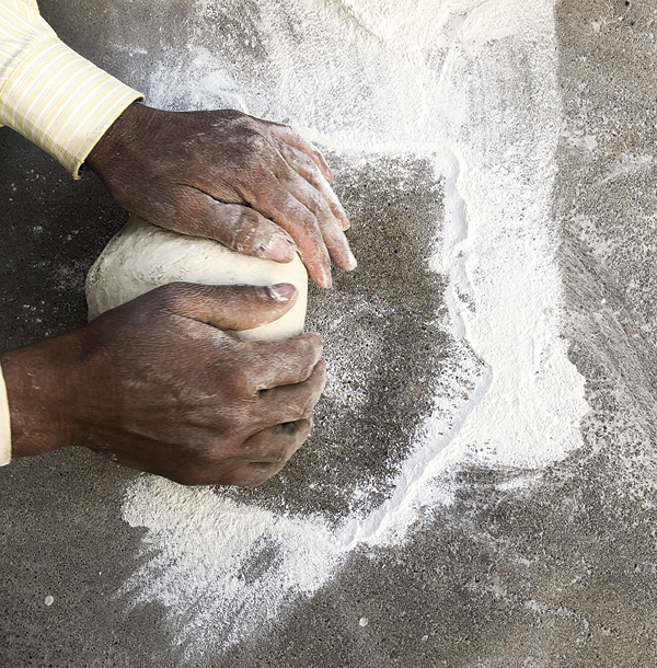 4 Traditional Jaipur Blue Pottery material being kneaded to create a clay-like dough by an artisan in Sanganer.