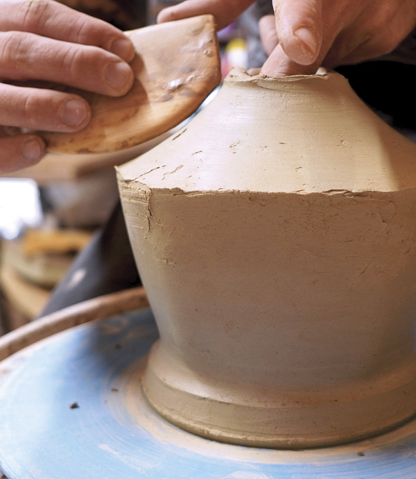 2 Score, slip, and blend a thick coil that can be thrown into the shoulder. Pinch the coil inward until the shoulder is close to the desired finished thickness. With a small amount of water, throw the shoulder of the pot, smooth, and finish the rim.