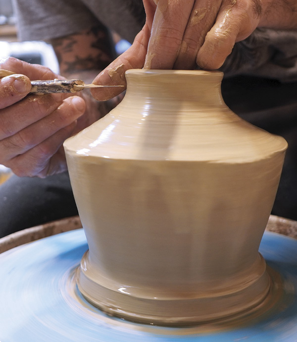 3 With a small amount of water, throw the shoulder of the pot smooth, trim the top level, as needed, and finish the rim.