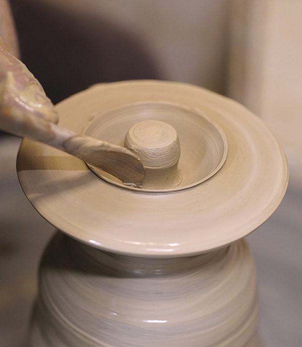 5 Isolate and center a small amount of clay at the top of the hump. Open off-center to create a finial.