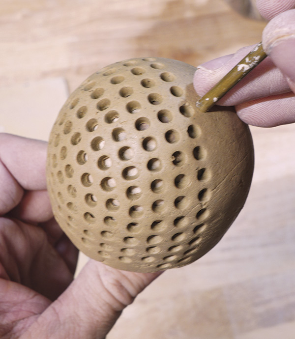 10 Pierce the strainer holes close together. Remove the strainer from the mandrel to firm up slightly.