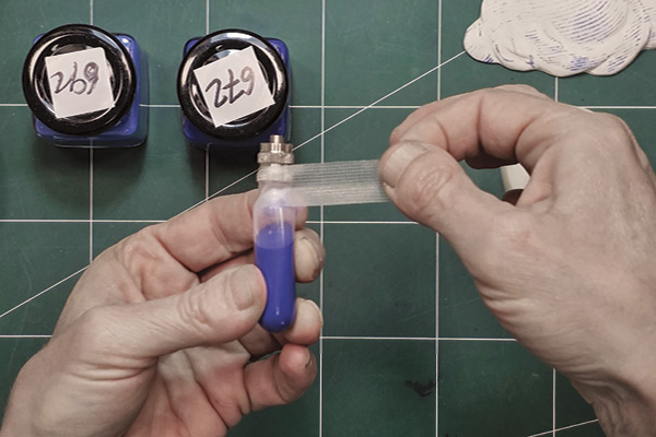 3 Insert the metal applicator connector and use a strip of 3M Transpore Surgical Tape to seal the connection point.