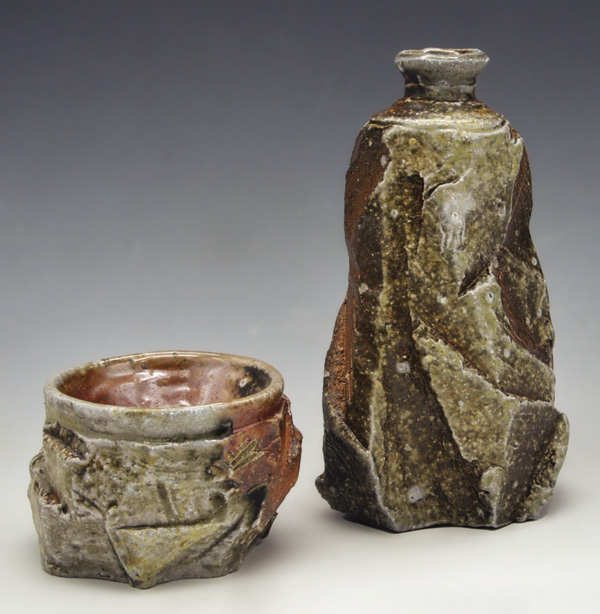 2 Barbara Allen’s faceted tokkuri with guinomi, to 7 in. (17 cm) in height, wheel-thrown and altered stoneware with feldspar inclusions, wood fired to cone 11, 2022.