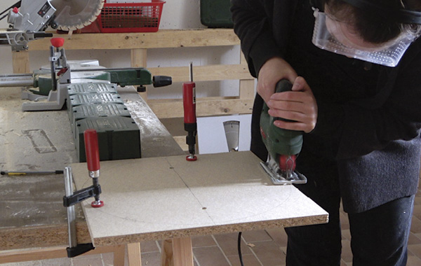 5 After securely clamping the board to a work surface, cut out the bat with a jigsaw.