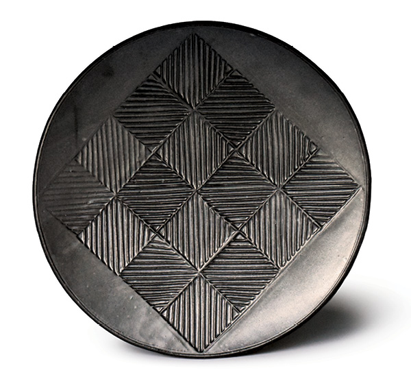 1 Platter, 18 in. (46 cm) in diameter, thrown stoneware, stamped pattern, matte-black glaze, fired to cone 10 in reduction.