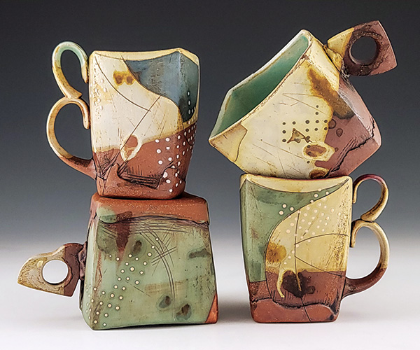 2 Dehmie Dehmlow’s mugs, to 8 in. (20.32 cm) in height, cone-6 red clay, colored terra sigillatas, glazes, Mayco Stroke and Coat glazes, red iron oxide wash, borax wash, 2024. Photo: Companion Gallery.