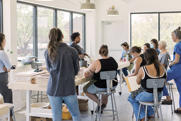 3 Attendees listen attentively during Tammie Rubin’s “Clay as Canvas” workshop.