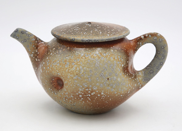 1 Jason Wang’s Titanium Yellow Orange Teapot, 5 in. (12.7 cm) in height, wheel-thrown white stoneware, flashing slip, glaze, fired to cone 10 in a soda kiln, 2025.