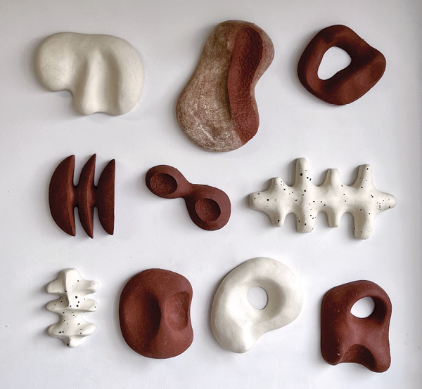 5 Janice Cormier's Fossilis, a collection of wall pieces to arrange freely, grouped or alone, made from various clays, some inclusions such as mudstone.
